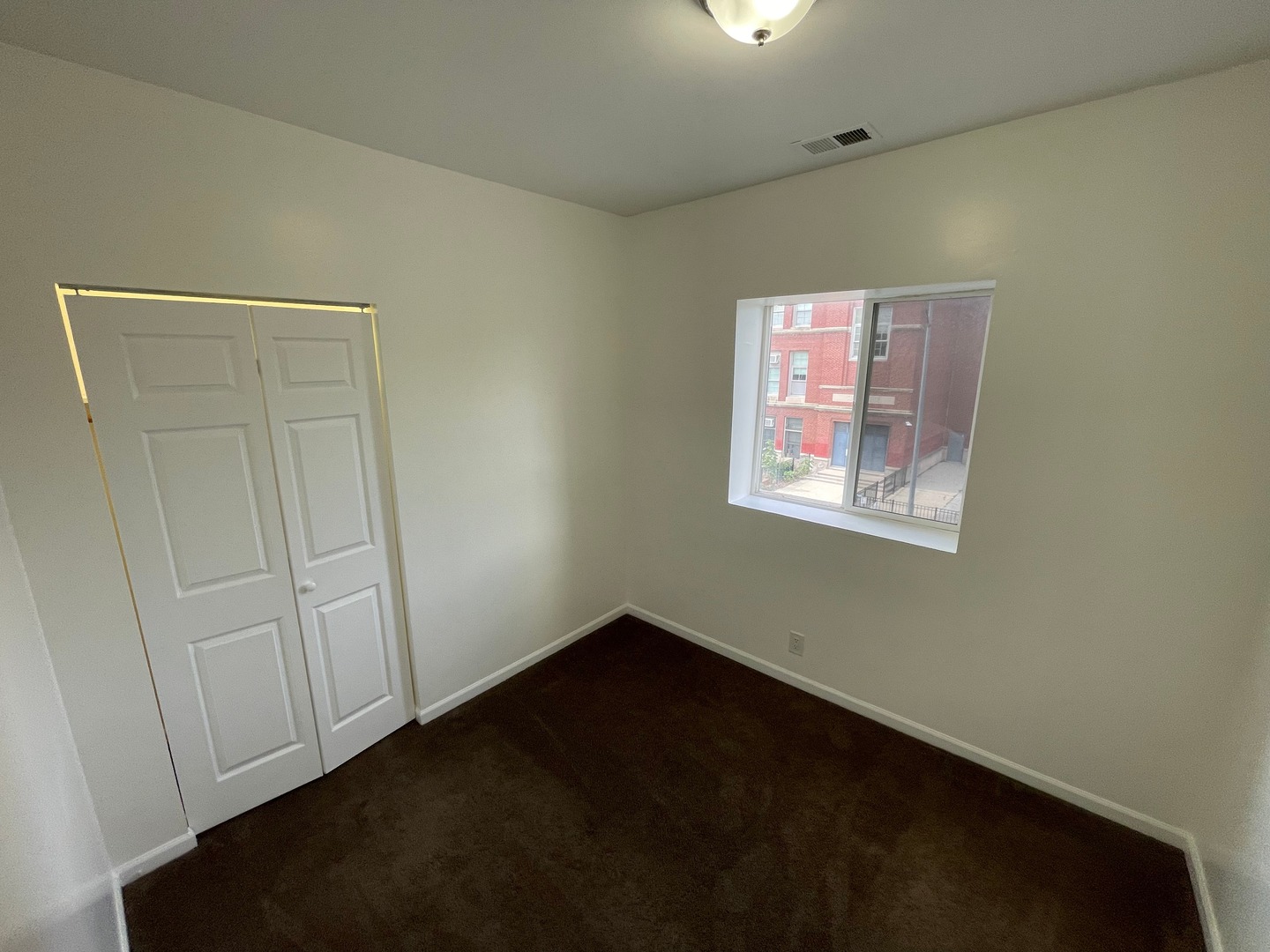 649 East Marquette Road, Unit 3 Chicago, IL 60637 - Photo 8 of 15 a view of an empty room with a window
