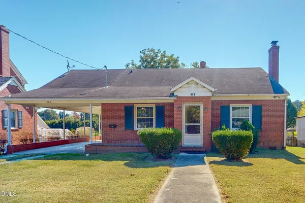 a view of a house with pool and a yard