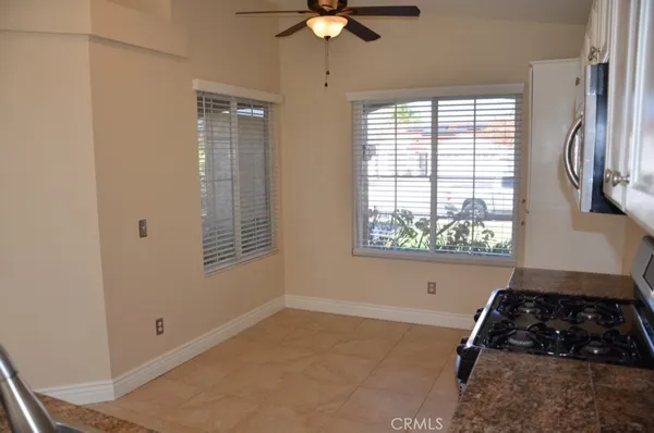 a kitchen with windows and a stove