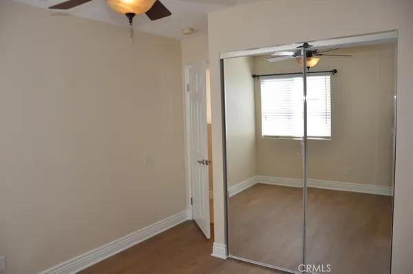 an empty room with window and wooden floor
