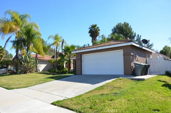 a front view of house with yard and trees