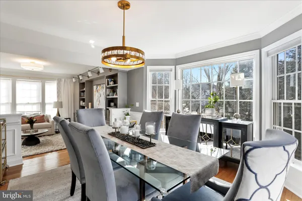 a kitchen with a table chairs refrigerator and cabinets