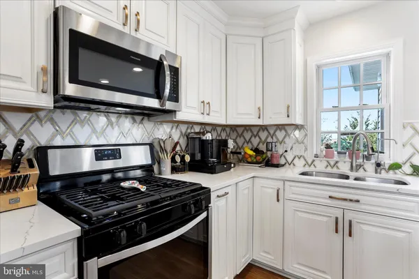a view of living room kitchen with stainless steel appliances granite countertop living room and living room