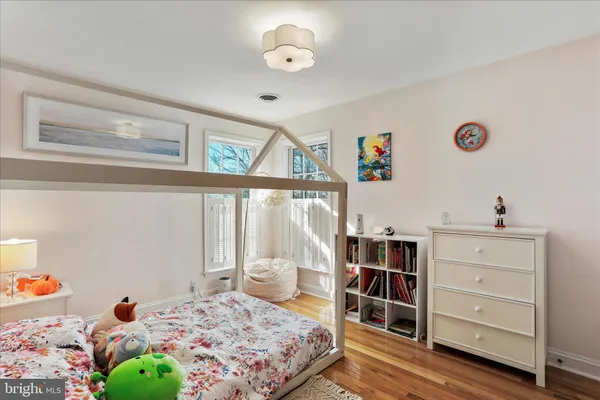 a bedroom with a bed and painting on the wall