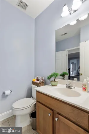 a room with gym equipment and wooden floor