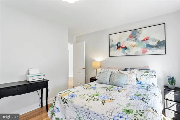 a room with gym equipment and wooden floor