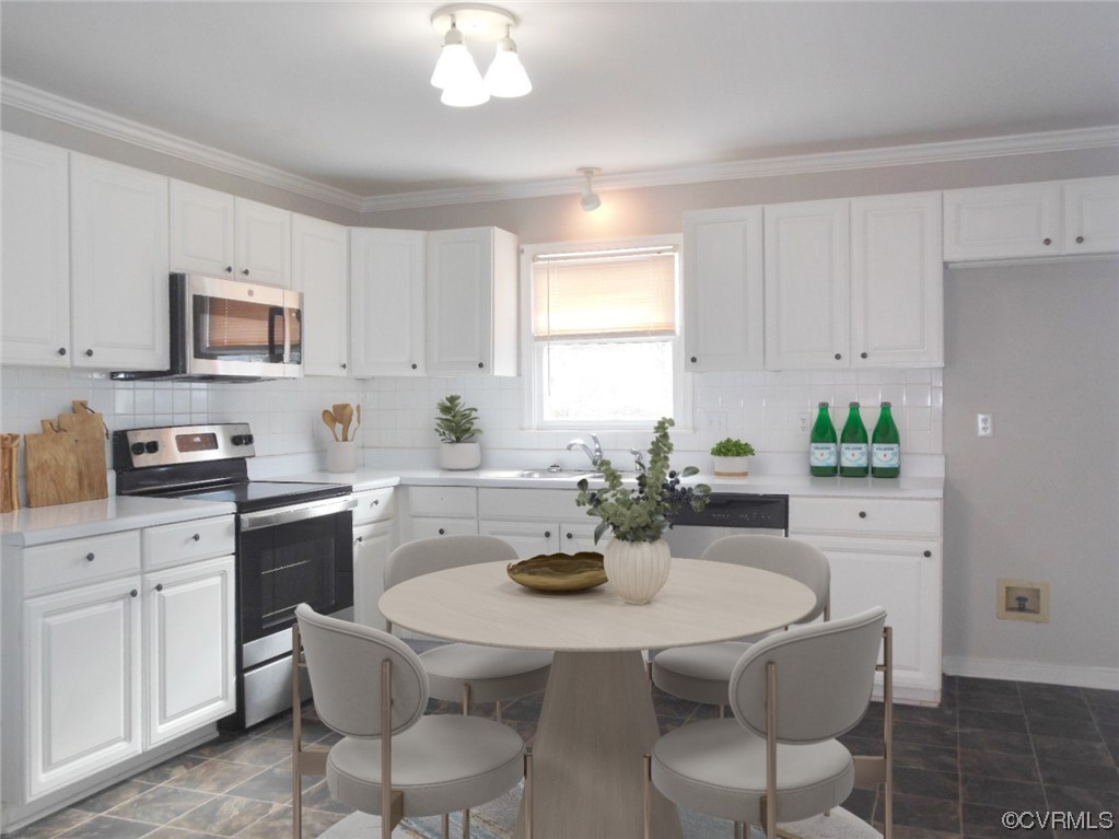 7447 Trailing Rock Road Prince George, VA 23875 - Photo 11 of 28 a kitchen with stainless steel appliances granite countertop white cabinets a sink a stove a dining table and chairs