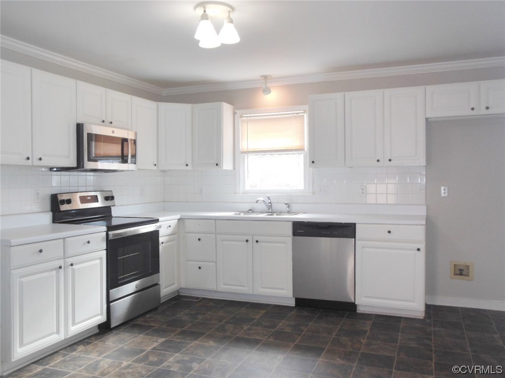 7447 Trailing Rock Road Prince George, VA 23875 - Photo 12 of 28 a kitchen with white cabinets and white appliances
