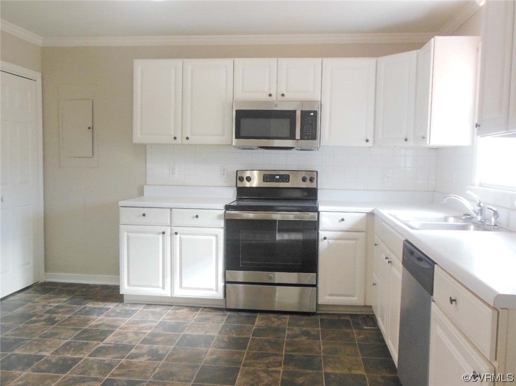 7447 Trailing Rock Road Prince George, VA 23875 - Photo 13 of 28 a kitchen with a sink stove and cabinets