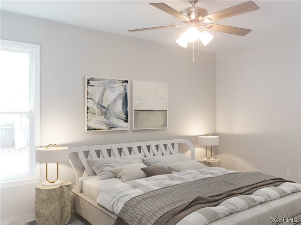 7447 Trailing Rock Road Prince George, VA 23875 - Photo 17 of 28 a bedroom with a bed and a chandelier