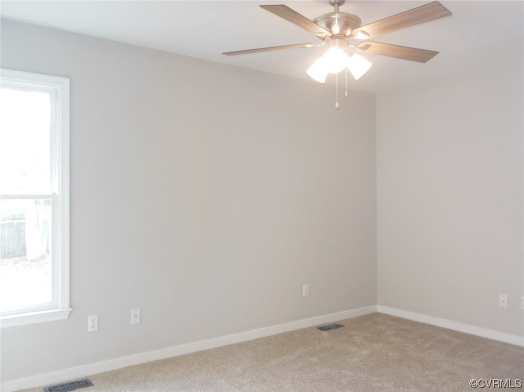 7447 Trailing Rock Road Prince George, VA 23875 - Photo 18 of 28 an empty room with a window and a fan