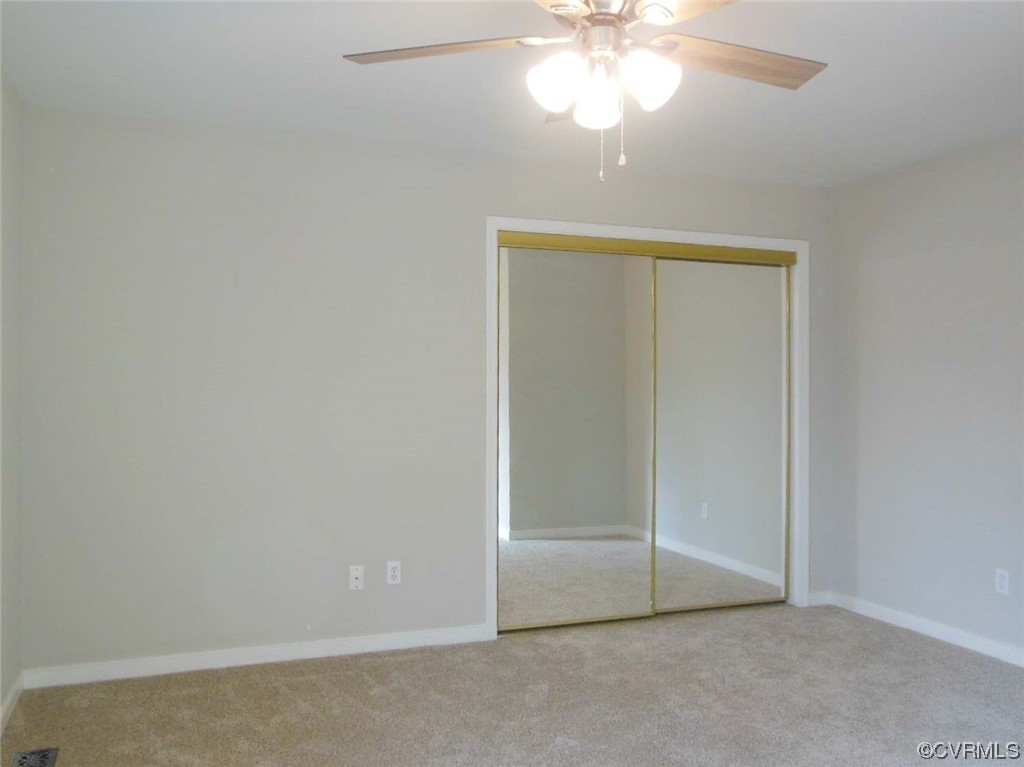 7447 Trailing Rock Road Prince George, VA 23875 - Photo 19 of 28 an empty room with a chandelier fan