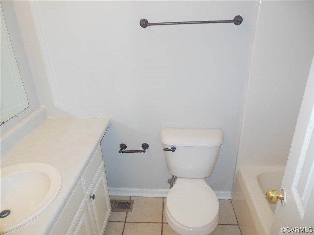 7447 Trailing Rock Road Prince George, VA 23875 - Photo 27 of 28 a white toilet sitting next to a bathroom sink