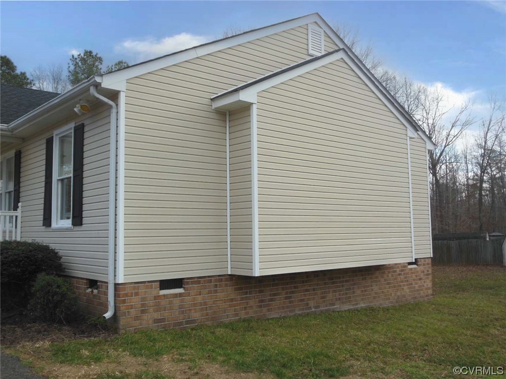 7447 Trailing Rock Road Prince George, VA 23875 - Photo 3 of 28 a view of a white house next to a yard