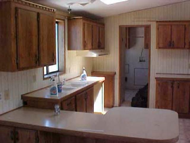 1130 Hazen Road Yakima, WA 98903 - Photo 3 of 9 a kitchen with kitchen island a sink appliances and cabinets