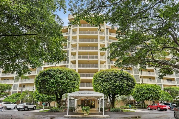 a front view of a building and trees