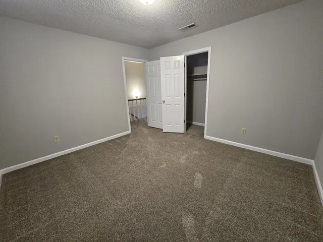 an empty room with windows and entrance