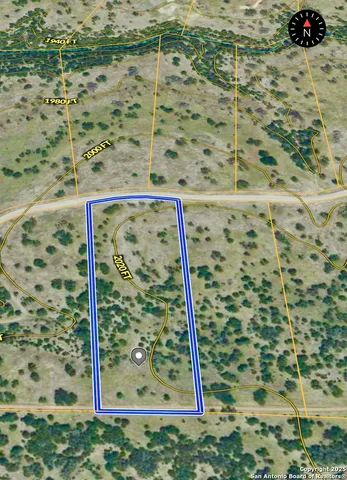 a view of a backyard with a garden and patio