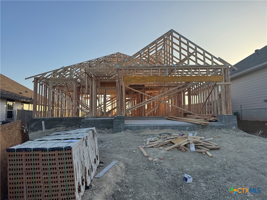 a view of a house with a yard and wooden fence