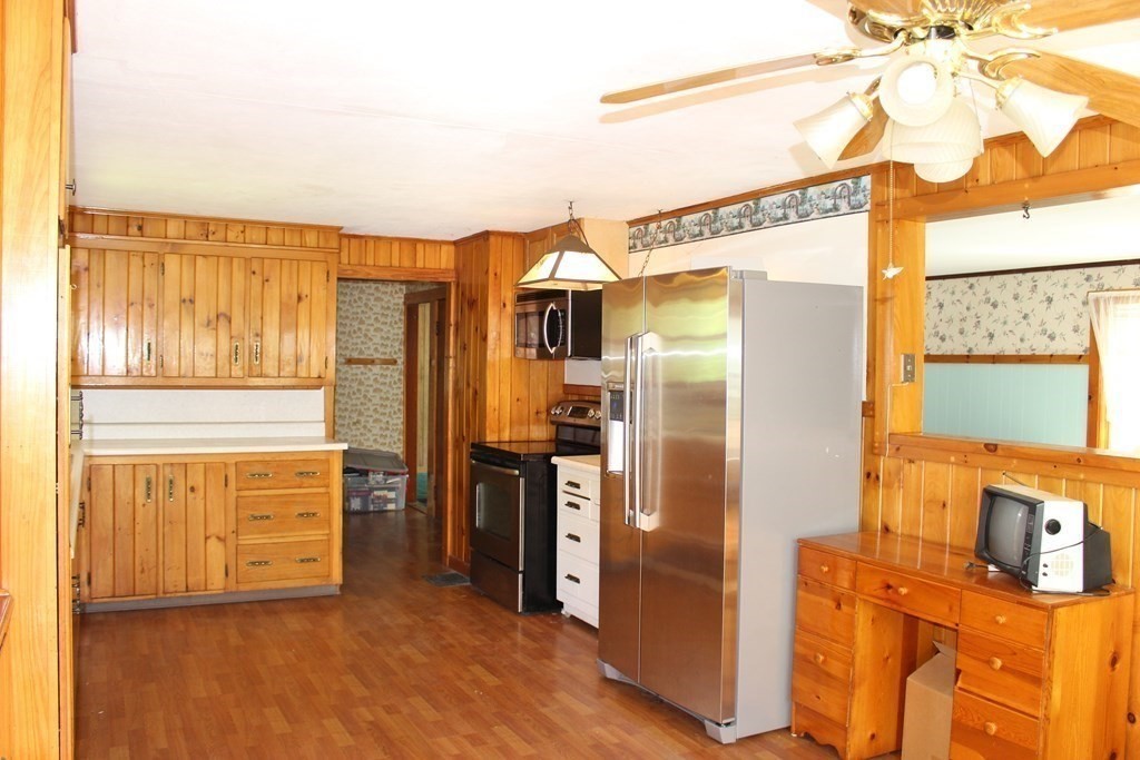 45 Orange Road Warwick, MA 01378 - Photo 3 of 11 a kitchen with stainless steel appliances granite countertop a refrigerator and a stove top oven