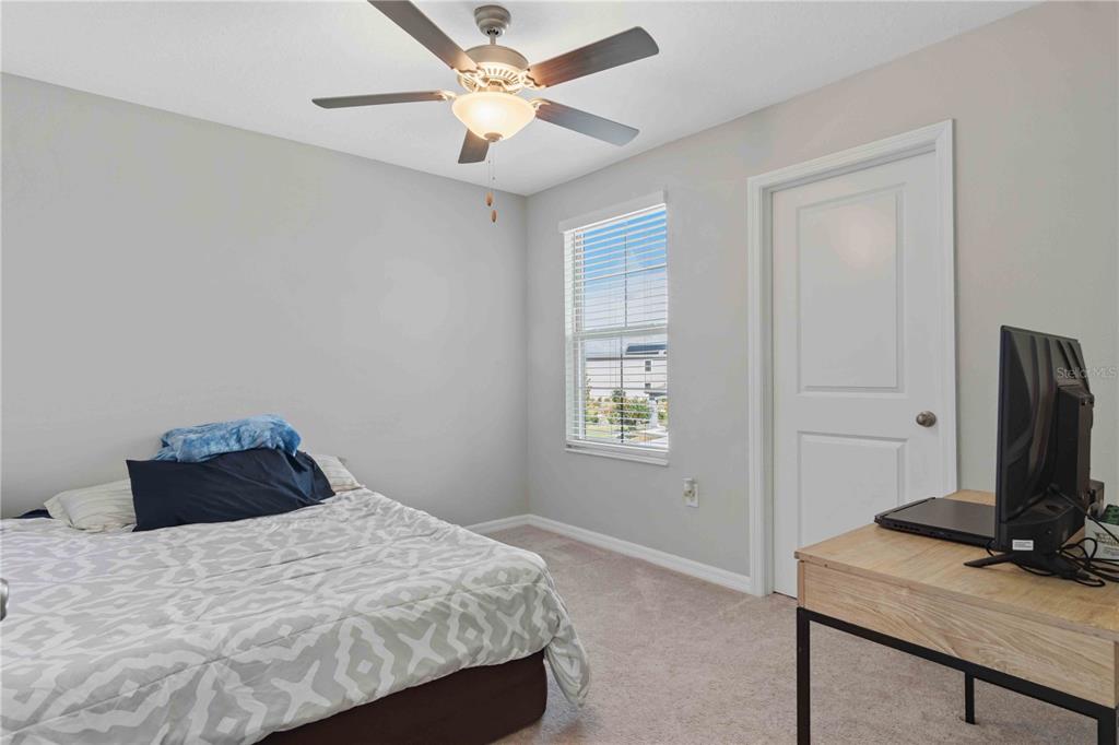 9440 Lemon Drop Loop Sun City Center, FL 33573 - Photo 39 of 55 a bedroom with a bed and a flat screen tv