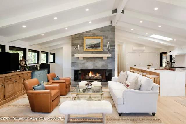a view of a patio with couches table and chairs and potted plants