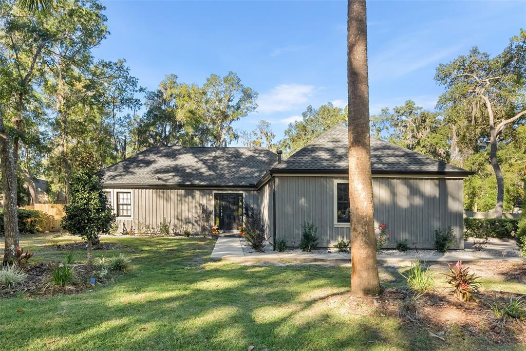 a front view of a house with a yard garage and outdoor seating