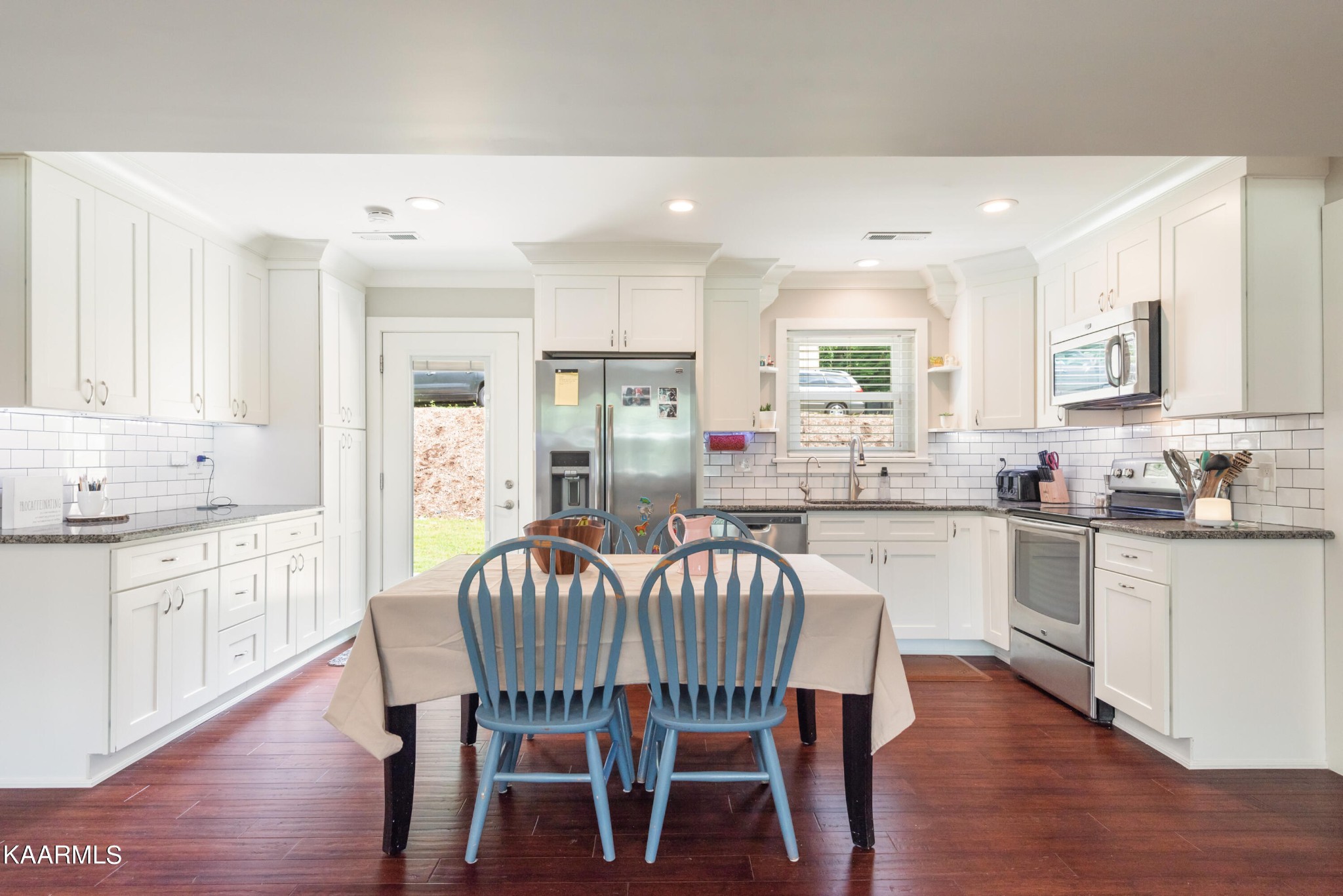 6034 Pleasant Ridge Road Knoxville, TN 37912 - Photo 5 of 40 a kitchen with granite countertop white cabinets and stainless steel appliances