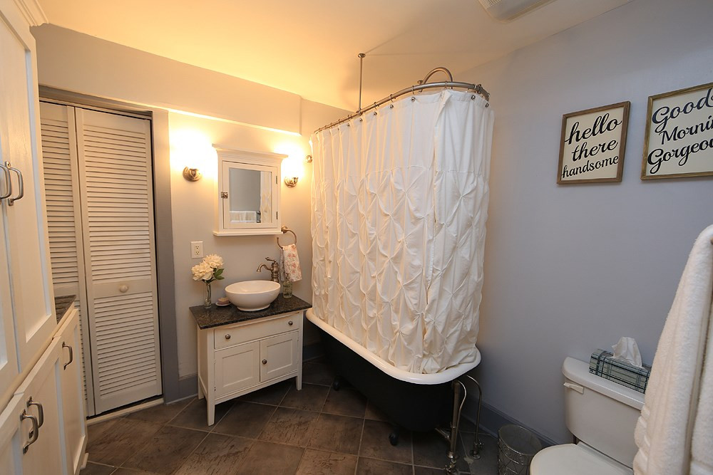1530 Carson Street Raleigh, NC 27608 - Photo 11 of 21 Updated master bath has claw foot tub w/ shower and updated cabinetry. Master Bathroom