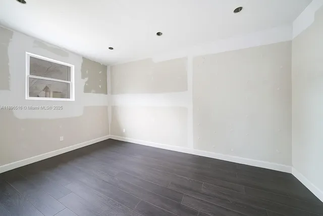 a bed room with a bed and a potted plant