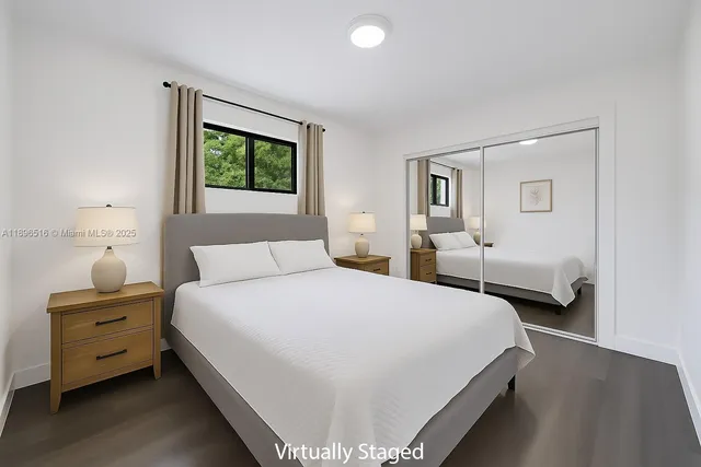 a bedroom with a bed and a potted plant