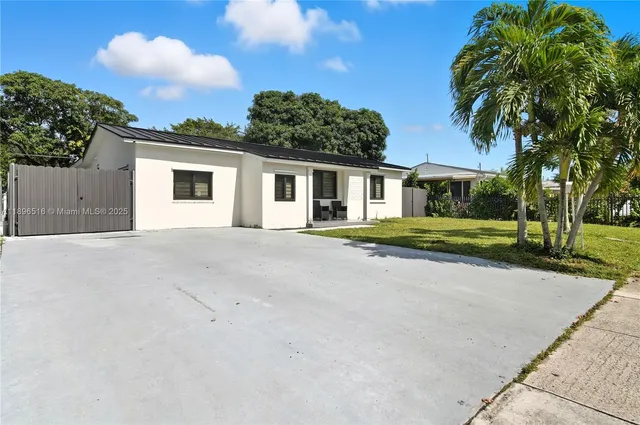 an aerial view of a house with yard
