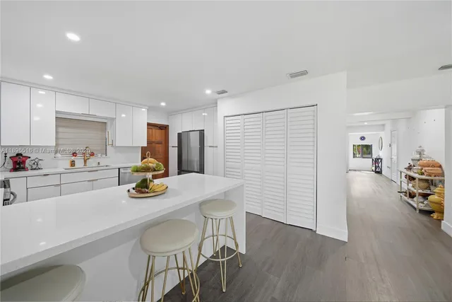 a view of a dining room with furniture and a wooden floor