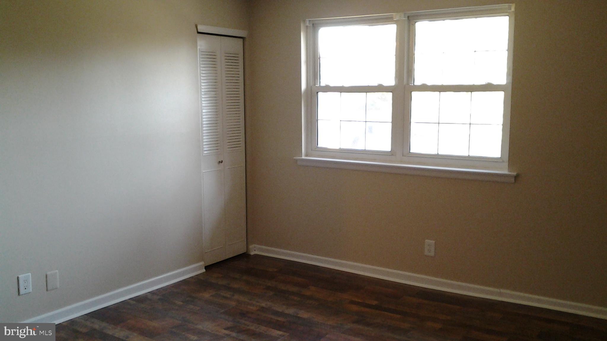 37 Eaves Mill Road Medford, NJ 08055 - Photo 5 of 14 an empty room with wooden floor and windows