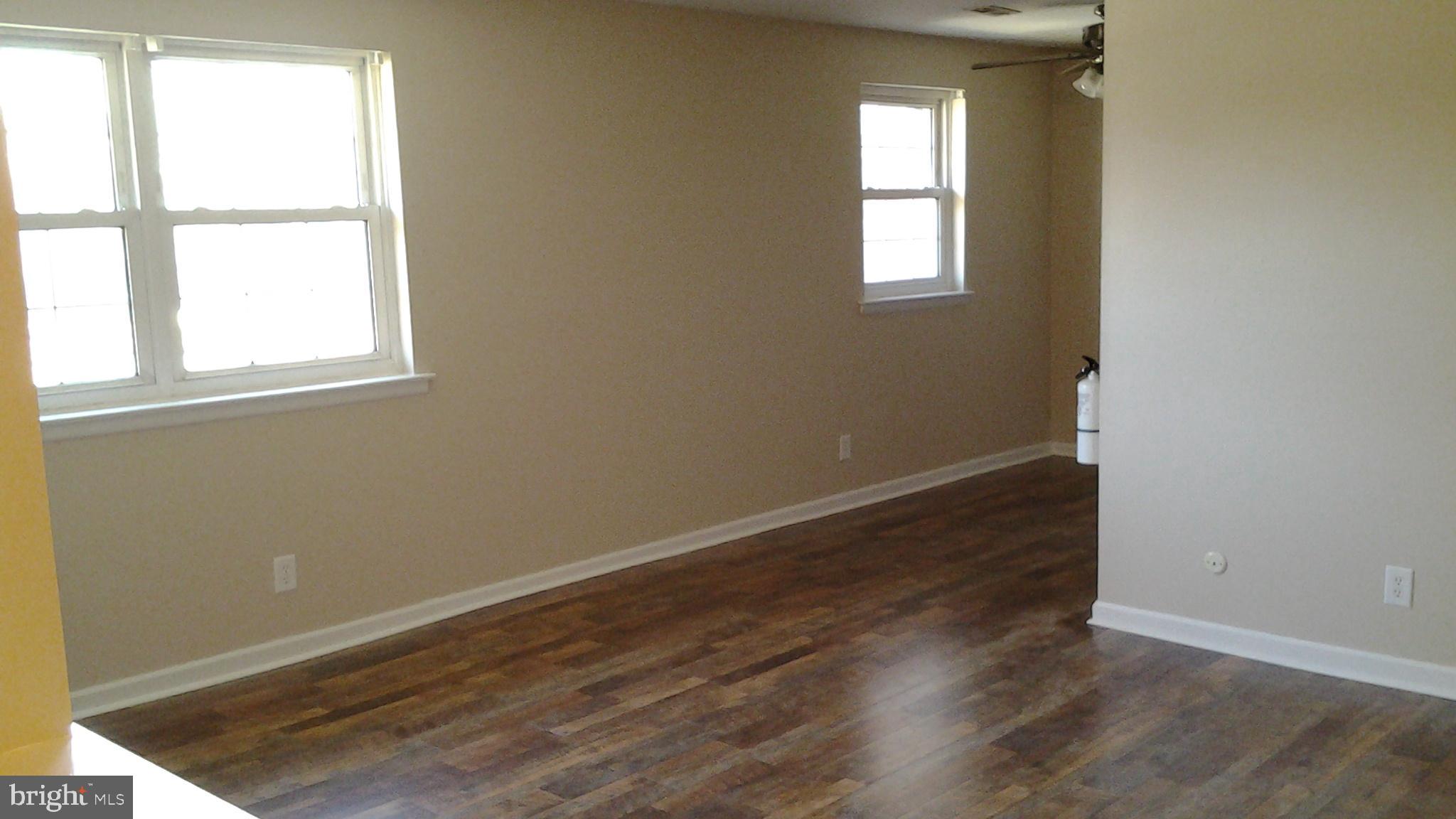 37 Eaves Mill Road Medford, NJ 08055 - Photo 6 of 14 an empty room with wooden floor and windows