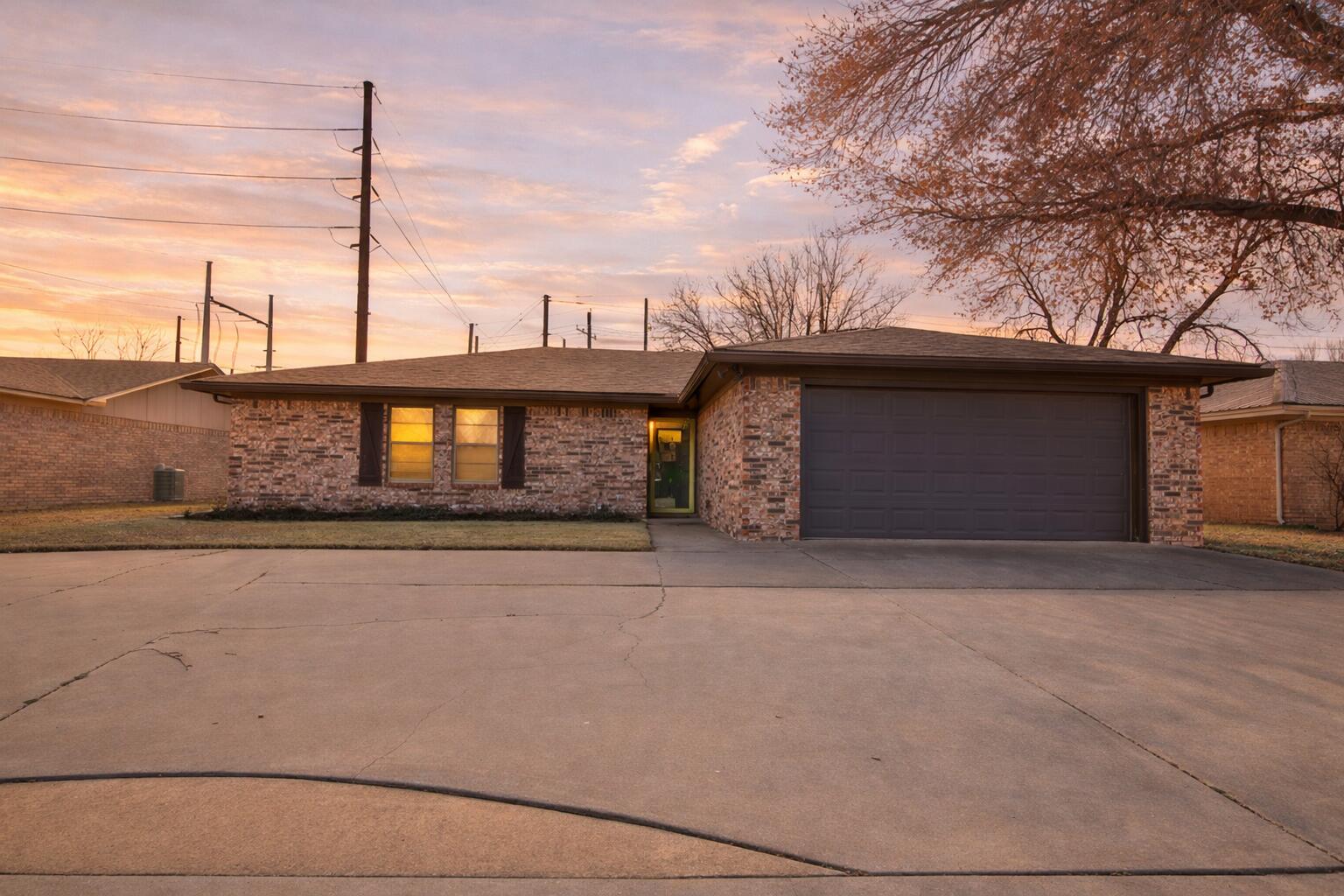 4805 73rd Street Lubbock, TX 79424 - Photo 1 of 26 a front view of a house with a garage