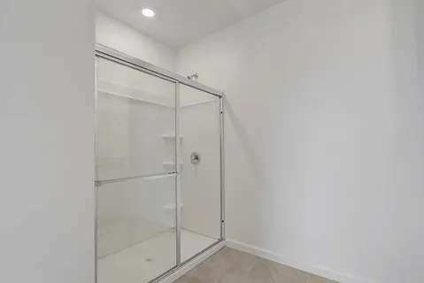 a bathroom with a glass shower door