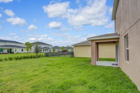 a view of a house with a yard and plants
