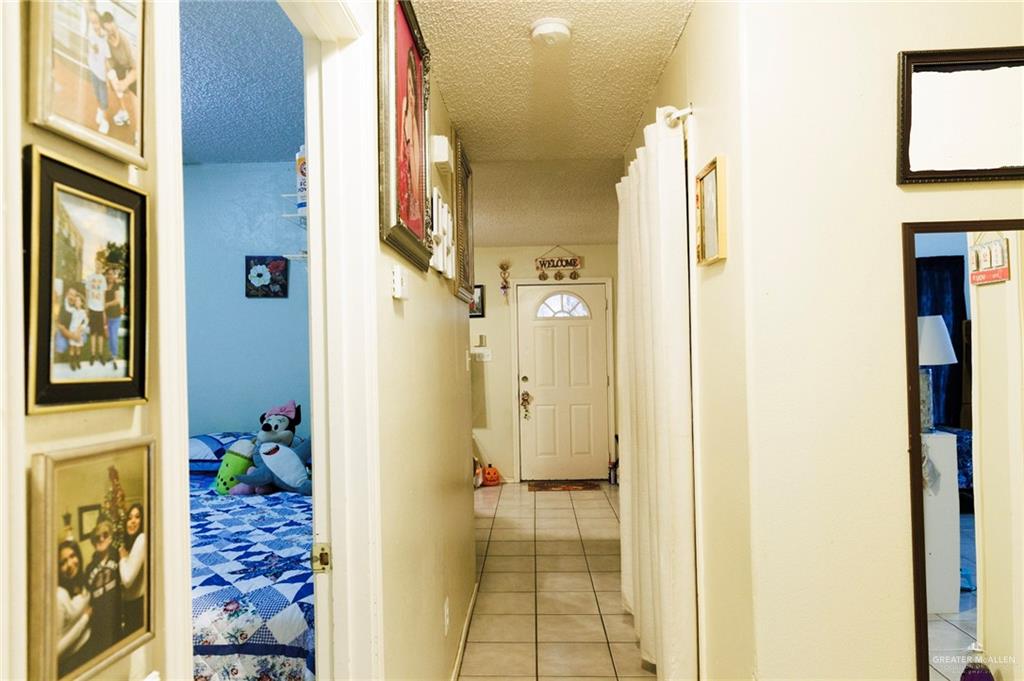 808 West Starr Avenue Pharr, TX 78577 - Photo 13 of 18 Corridor with light tile patterned flooring and a textured ceiling