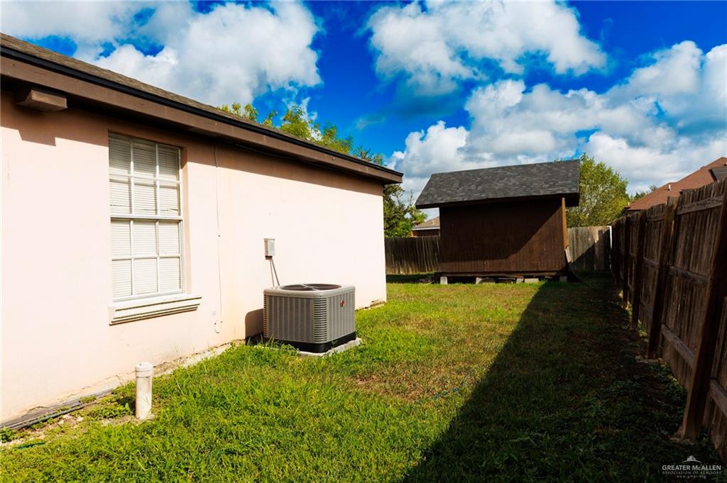 808 West Starr Avenue Pharr, TX 78577 - Photo 14 of 18 Fenced backyard with a storage shed