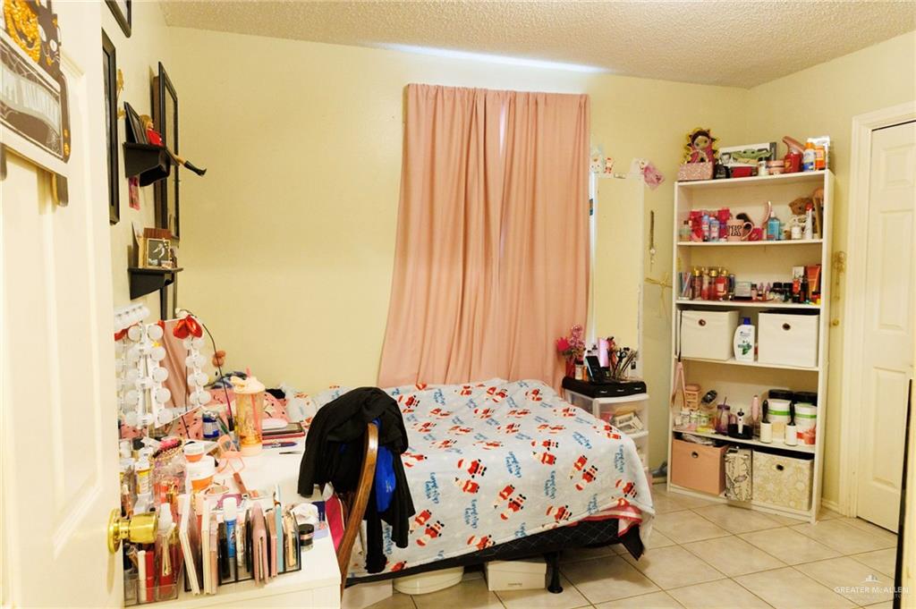 808 West Starr Avenue Pharr, TX 78577 - Photo 9 of 18 Bedroom featuring a textured ceiling and tile patterned flooring