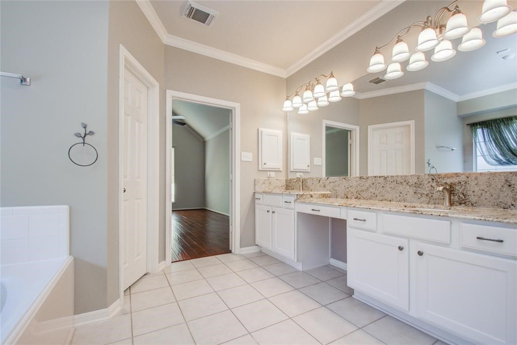 20011 Glen Lake Drive Spring, TX 77388 - Photo 25 of 31 a bathroom with a granite countertop sink a mirror and a vanity