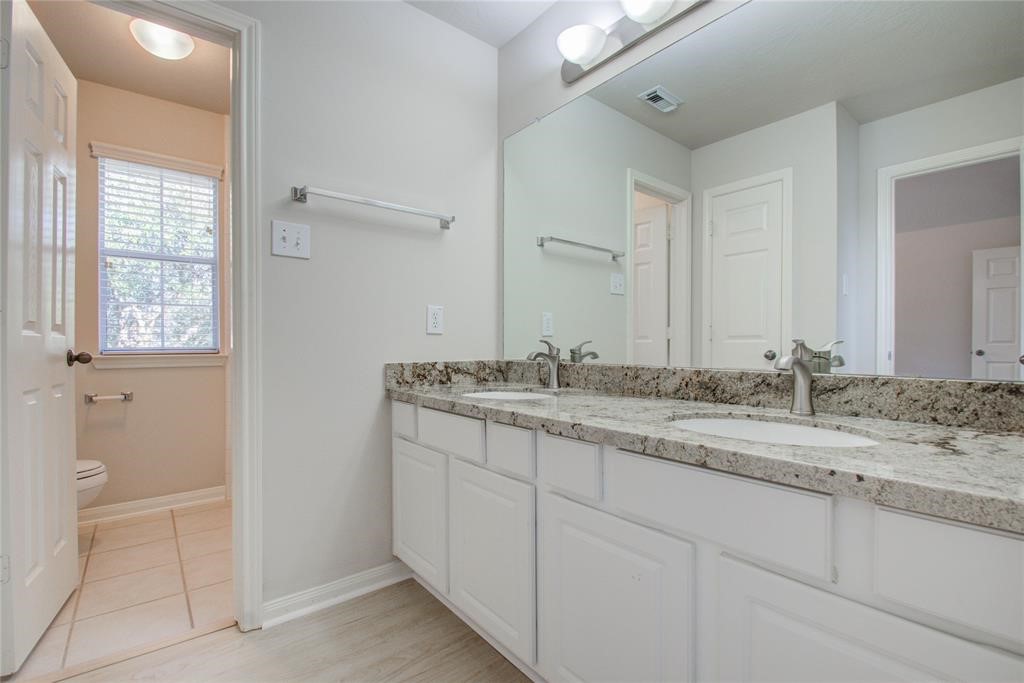 20011 Glen Lake Drive Spring, TX 77388 - Photo 28 of 31 a bathroom with a granite countertop sink and a mirror