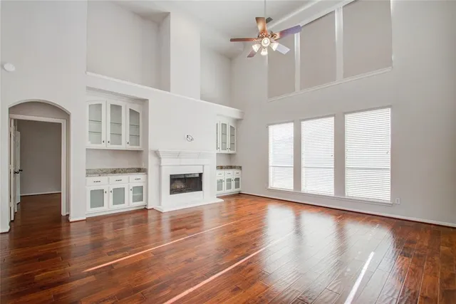 a view of a hallway with wooden floor and entryway