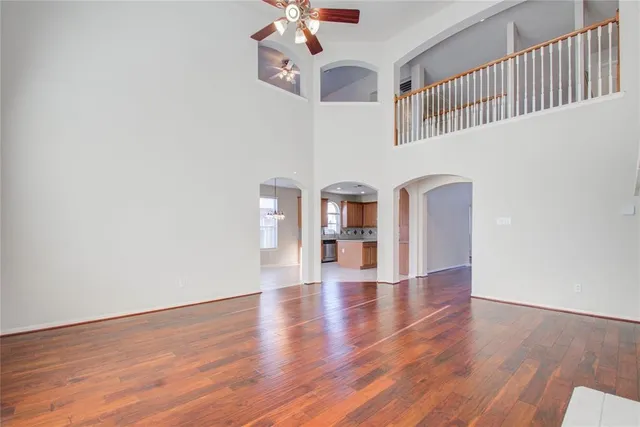 a view of a hallway with wooden floor and stairs