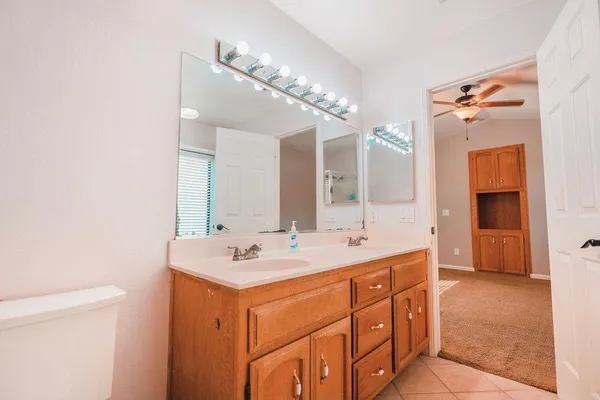 a bathroom with a sink a vanity and a mirror