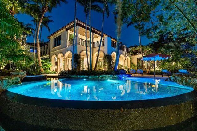 a view of a backyard with plants and outdoor seating