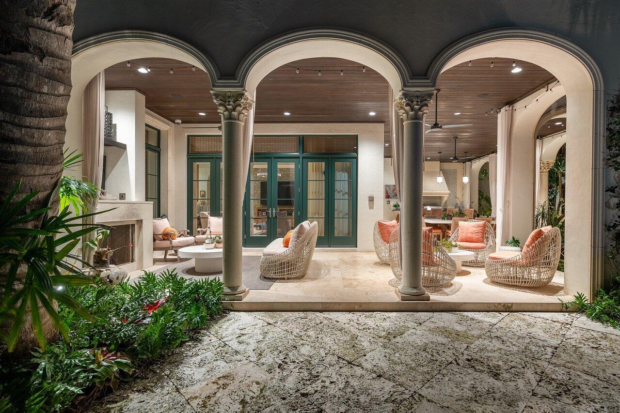 8 Driftwood Landing Road Gulf Stream, FL 33483 - Photo 24 of 67 a front view of a house with outdoor seating