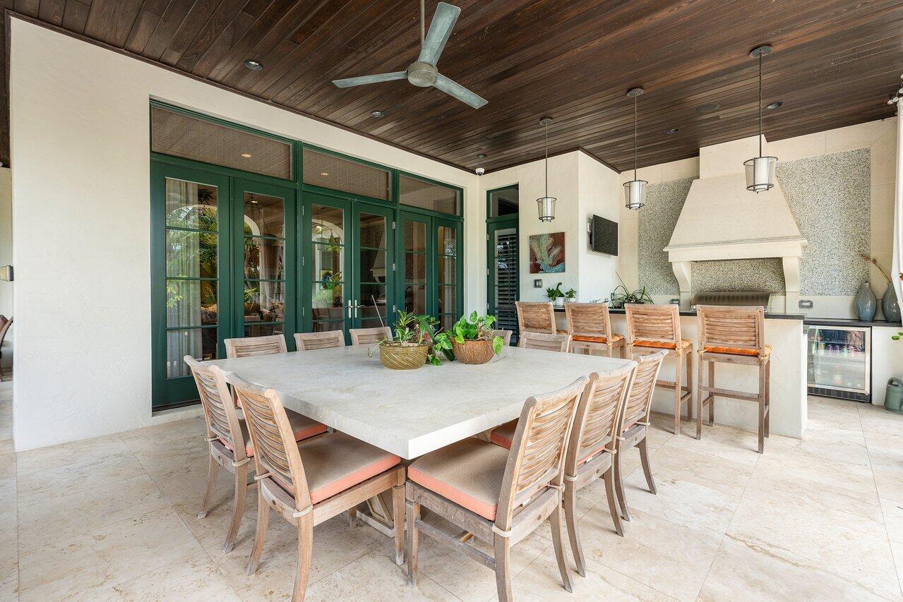 8 Driftwood Landing Road Gulf Stream, FL 33483 - Photo 25 of 67 a view of an outdoor dining space with a table and chairs