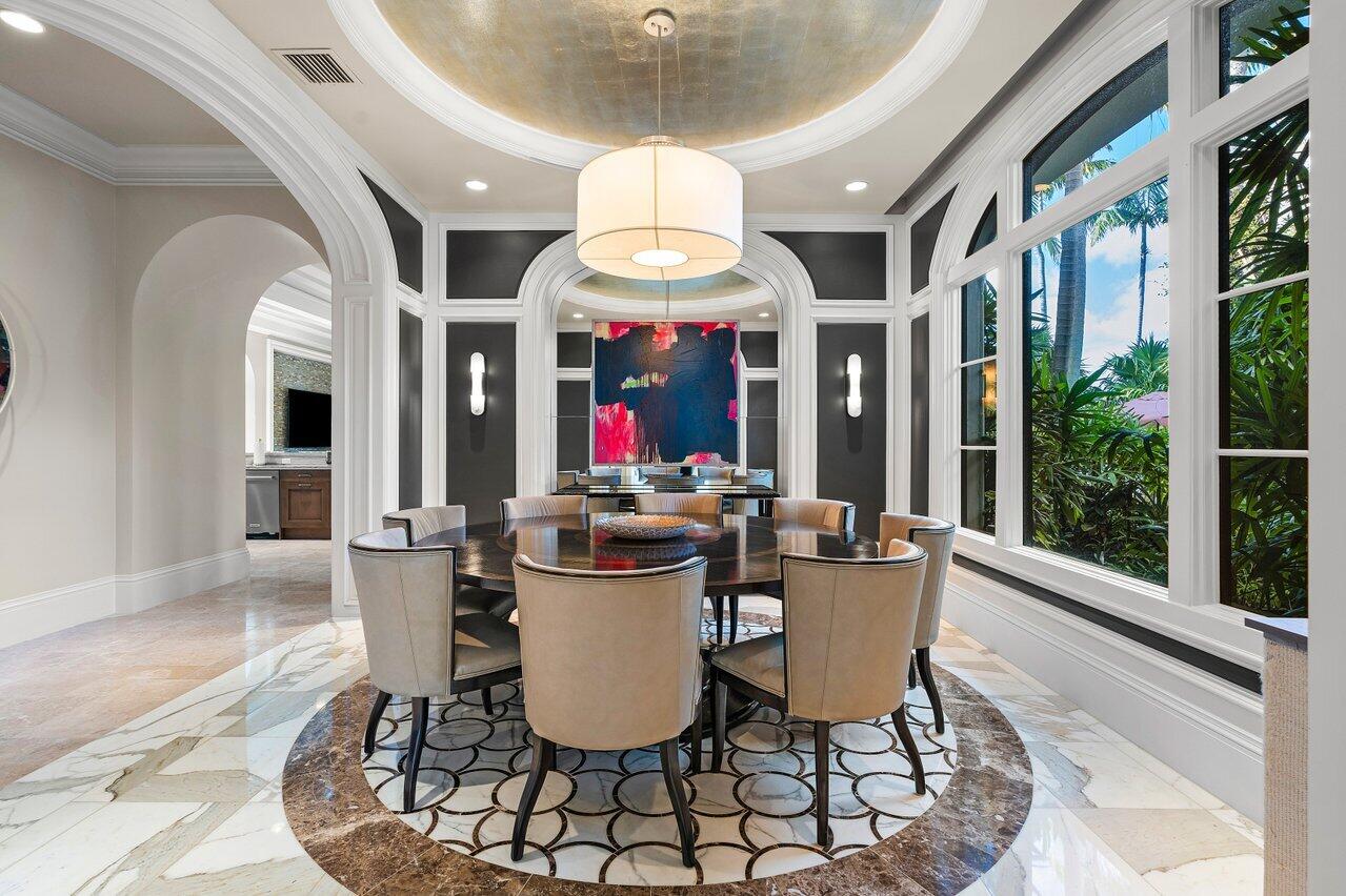 8 Driftwood Landing Road Gulf Stream, FL 33483 - Photo 35 of 67 a view of a dining room with furniture wooden floor and chandelier
